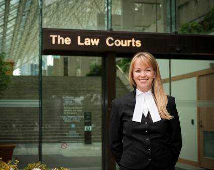 Woman lawyer standing in front of courthouse